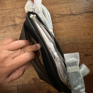 New with tags cross body Coach bag. Black with gold coach emblem.